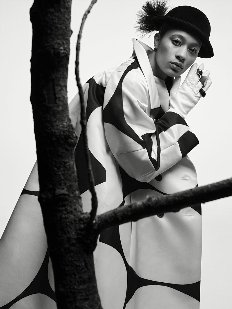 Model Selena Forrest wearing a patterned coat and bowler hat for D Repubblica photographed by Ethan James Green