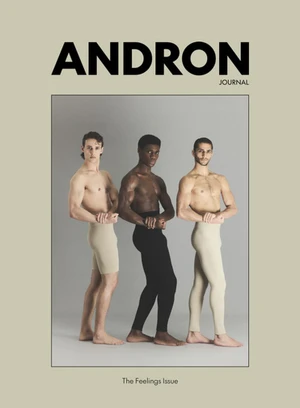 Three male models posing shirtless against a grey studio backdrop for a magazine cover editorial