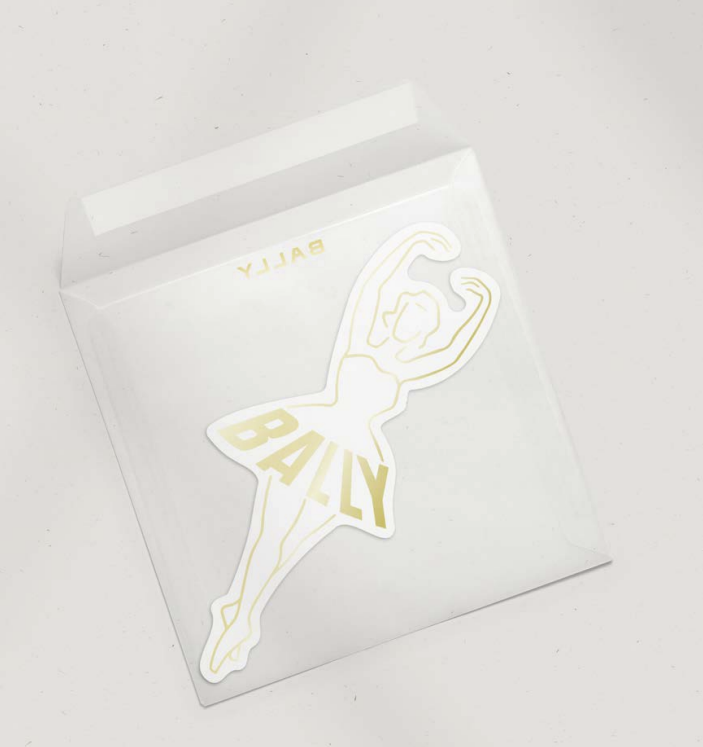 Gold-toned sticker of a ballerina in a white envelope, adding elegance and charm to stationary or branding projects.