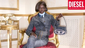 Model seated in an ornate gold armchair holding a denim handbag for Diesel 2026 ad campaign