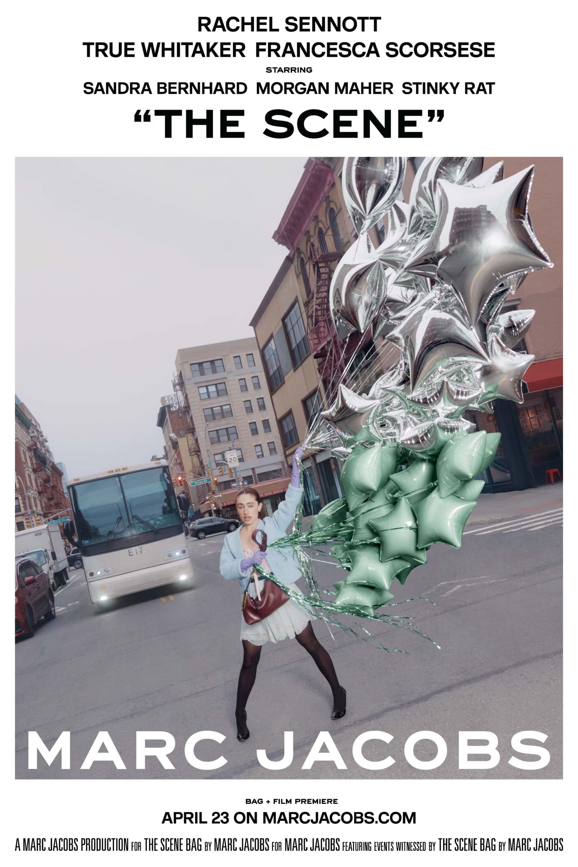 Model standing on a city street holding a large bunch of shiny silver star-shaped balloons for Marc Jacobs