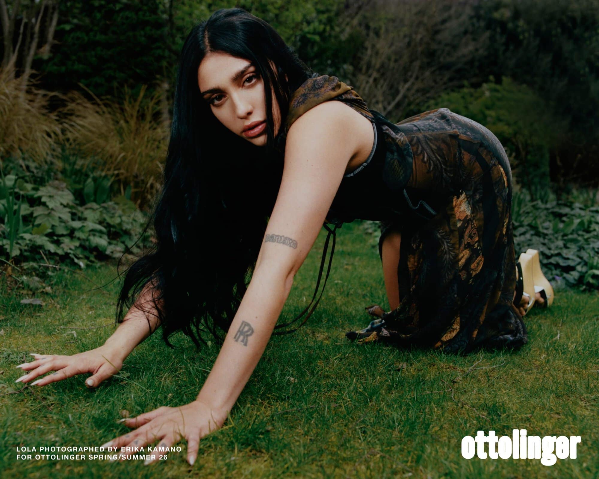 Model Lola Leon on green grass in a printed dress for Ottolinger Spring 2026 ad campaign