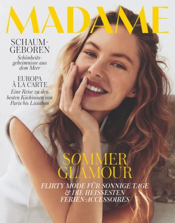 Magazine cover featuring a smiling woman with light brown wavy hair, fair skin, and natural makeup, promoting beauty and fashion.
