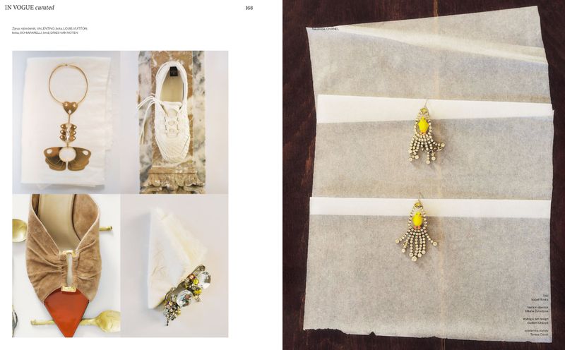 Editorial flat lay spread showcasing luxury designer jewellery, footwear, and accessories arranged on white tissue paper.