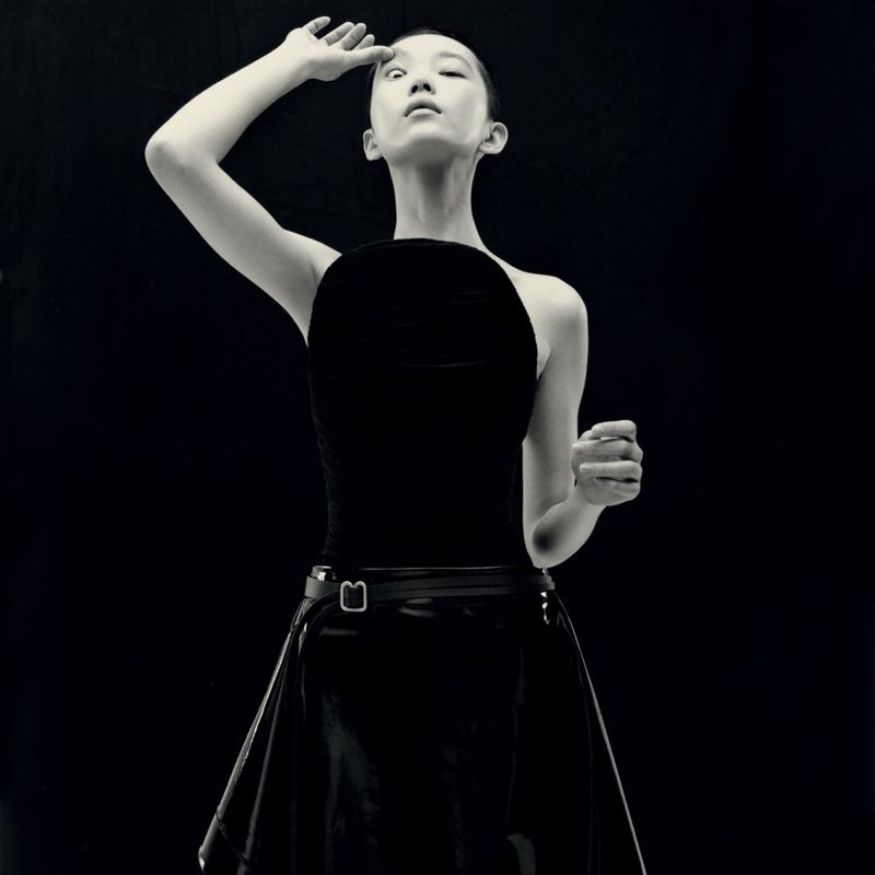Model in black top and skirt posing against a dark background, captured by Kito Munoz for Re-Edition Magazine.
