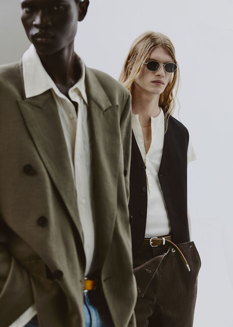 Two male models posing in menswear apparel against a neutral studio background