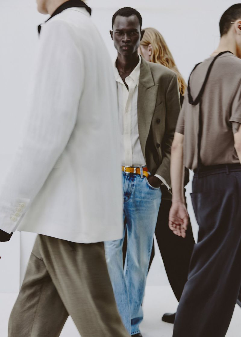 Group of male and female models walking against a clean white background wearing Zara menswear styles