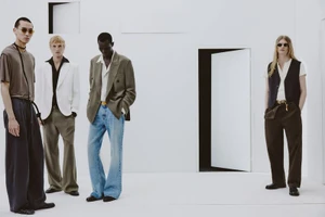 Four male models wearing contemporary Zara menswear against a minimalist white studio set with doors.