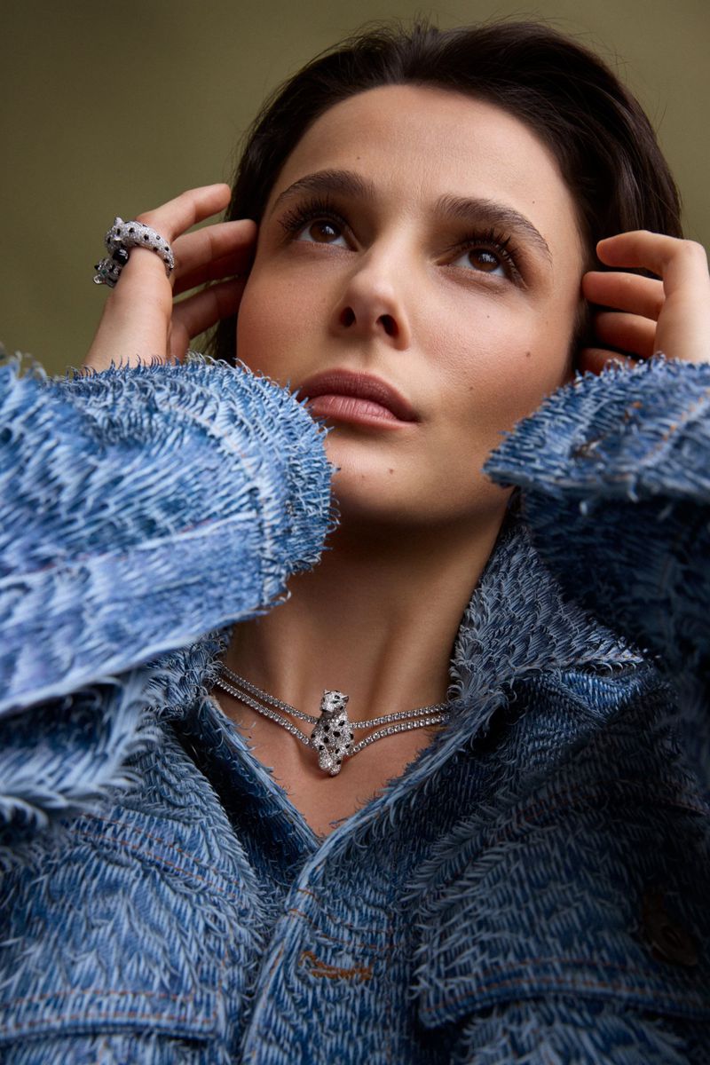 Close-up portrait of actress Busra Develi wearing a textured denim jacket and animal necklace for Elle Turkiye.