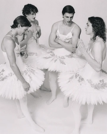 Four male dancers wearing white tutus and tights posed together in a studio setting for ODDA Magazine