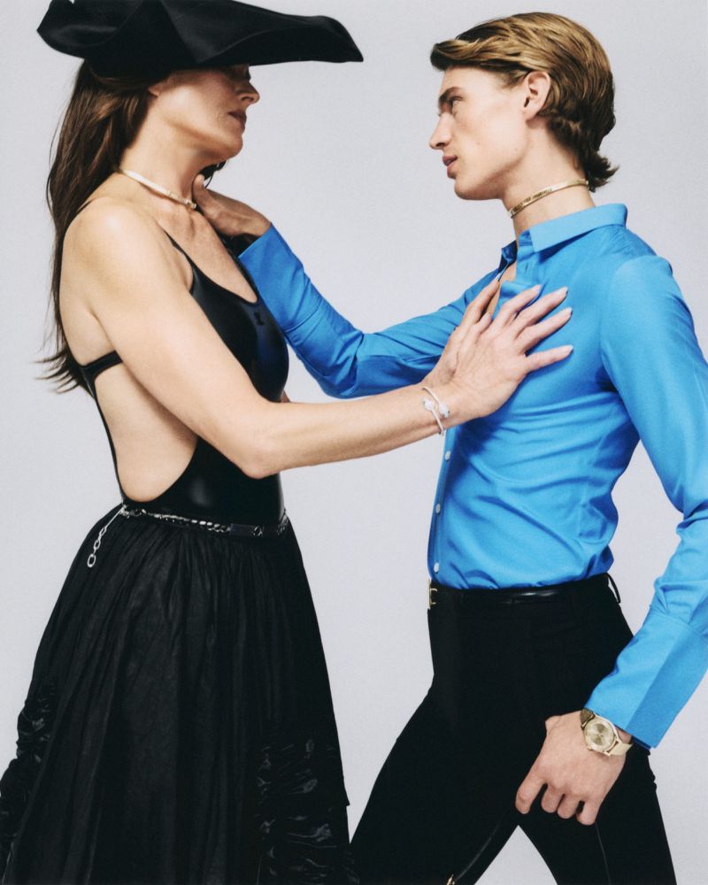 Brooke Shields in black dress with black hat facing a male model in blue shirt for ODDA Magazine