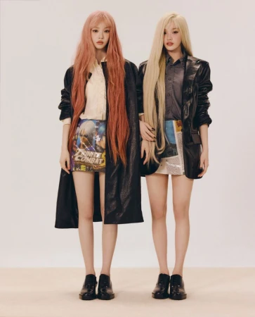 Two female models with long hair wearing black jackets and printed miniskirts against a plain light background for ODDA Magazine