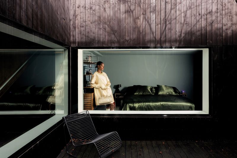Letitia Wright posing inside a lit bedroom framed by large architectural windows for ODDA Magazine