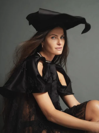 Model Isabeli Fontana wearing a black sculptural hat and black dress for ODDA Magazine editorial