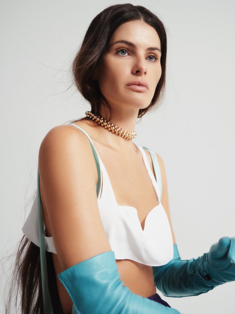 Isabeli Fontana wearing a white top and blue gloves for ODDA Magazine, photographed by Brendan Freeman.