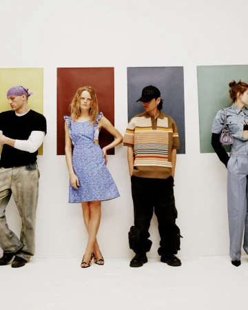Four models posing against a white studio wall featuring vertical rectangular color panels for ODDA Magazine