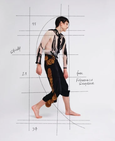 Model walking against a white background with overlaid Fibonacci sequence sketches and grid lines for ODDA Magazine.