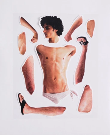 Cutout paper collage showing scattered body parts of a male model arranged on a white background for ODDA Magazine.