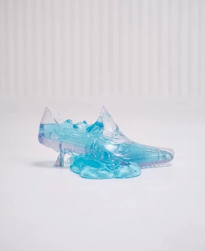 Transparent blue liquid shoe sculpture on white surface for ODDA Magazine