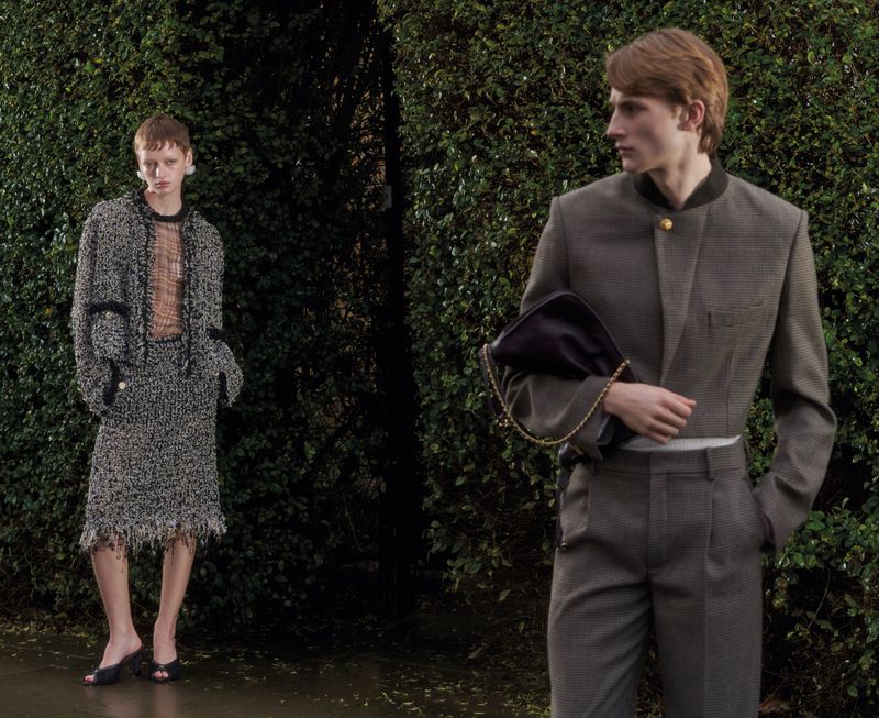 Two models posing outdoors before a dense green hedge for an editorial project titled The Debutants by ODDA Magazine.