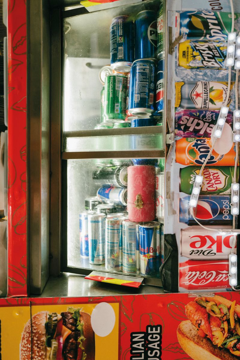Beverage cooler and food advertisements on the side of a street kiosk
