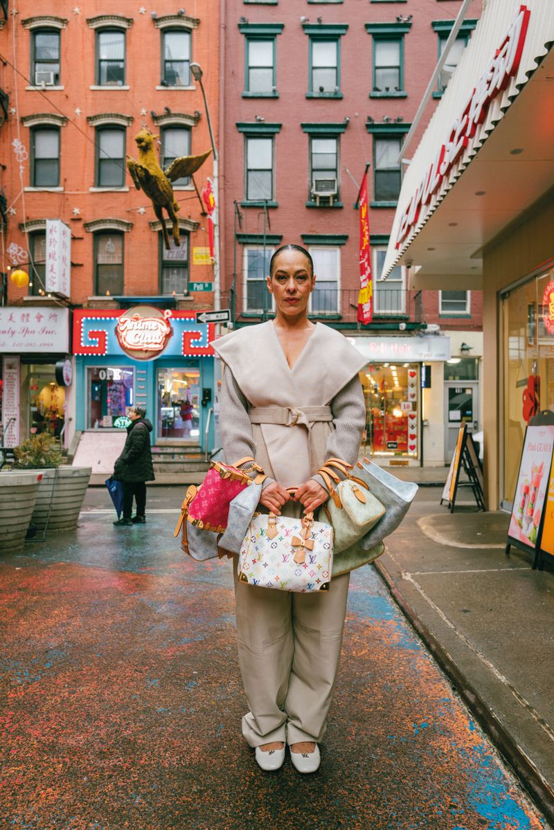 Model Carliane Paixao standing on an urban street carrying multiple handbags for ODDA Magazine