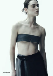 Model Lea Haesaert wearing a dark grey strapless top and black skirt against a seamless white background for Numéro Istanbul