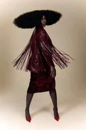 Venus Williams in a fringe jacket and dark skirt against a neutral backdrop for L'Officiel Italia.
