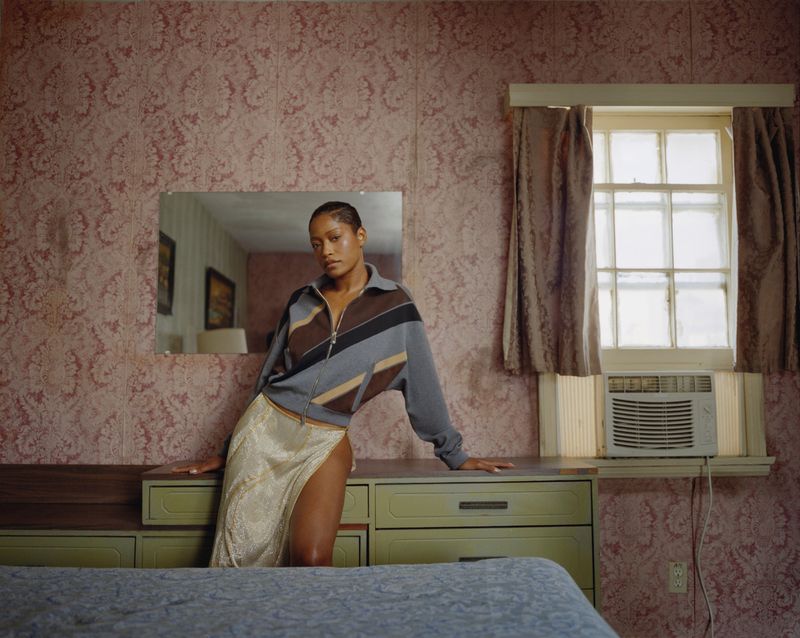 Keke Palmer leaning against a green dresser in a patterned room for Cultured Magazine