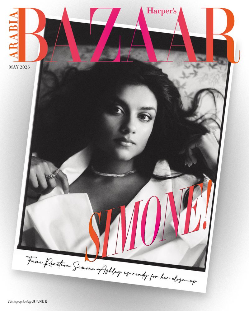 Black and white portrait of actress Simone Ashley in a white shirt and diamond necklace for Harper's Bazaar Arabia cover.