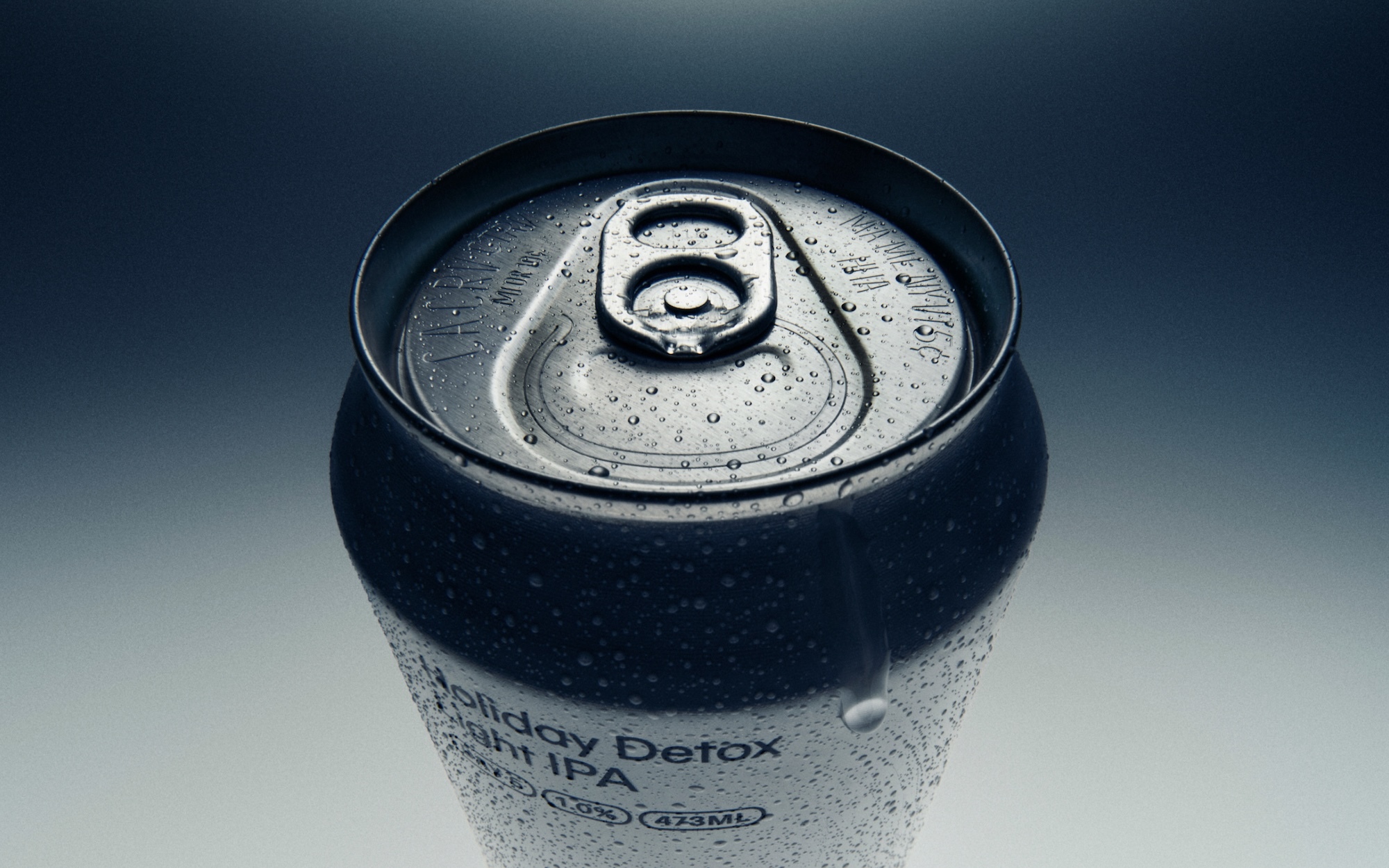 Close-up overhead shot of a beverage can covered in water droplets with dark lighting and a light gradient background.