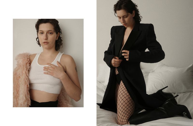 A woman poses in black blazer, fishnets, and high heels on a bed, juxtaposed with a closer view in a white crop top and coat.