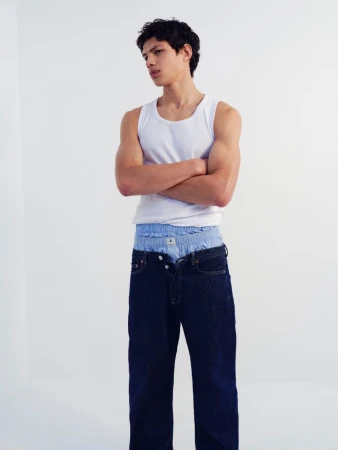 Model Ruben Moreira wearing a white tank top and dark jeans for Samsøe Samsøe
