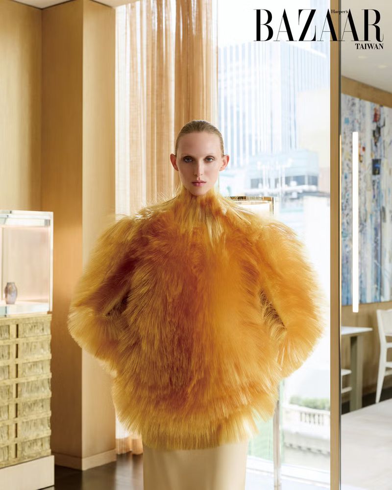Model Delilah Koch in an orange feathered top for Harper's Bazaar Taiwan magazine