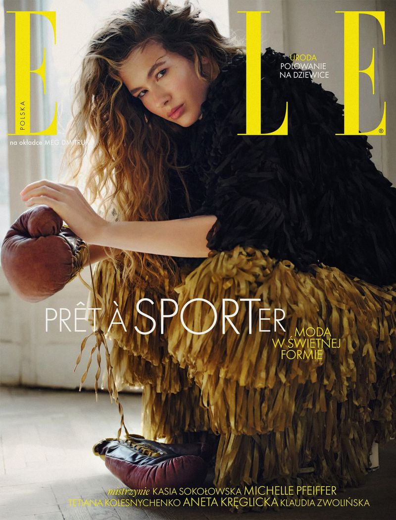 Meg Dmitruk on the cover of Elle Poland wearing a textured black top and holding vintage boxing gloves.