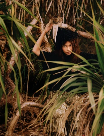 Model posed amidst dense tropical foliage for an editorial project titled ISLAND in Glass Magazine China