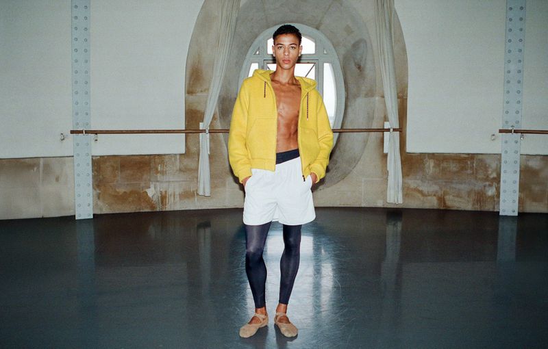 Dancer Guillaume Diop wearing a yellow zip hoodie and white shorts in El Pais Semanal editorial photography