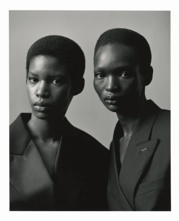 Two Black models with short hair wearing dark blazers against a plain studio background for SSAW Magazine