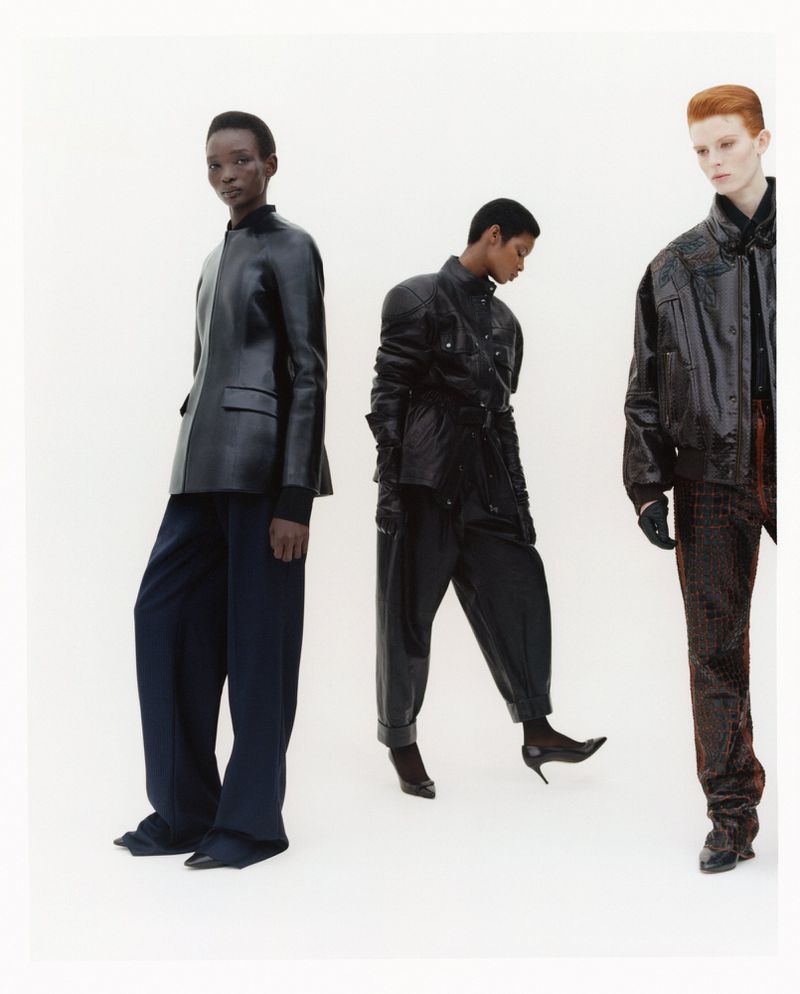Three models wearing black leather jackets and dark trousers posing against a plain white studio background.