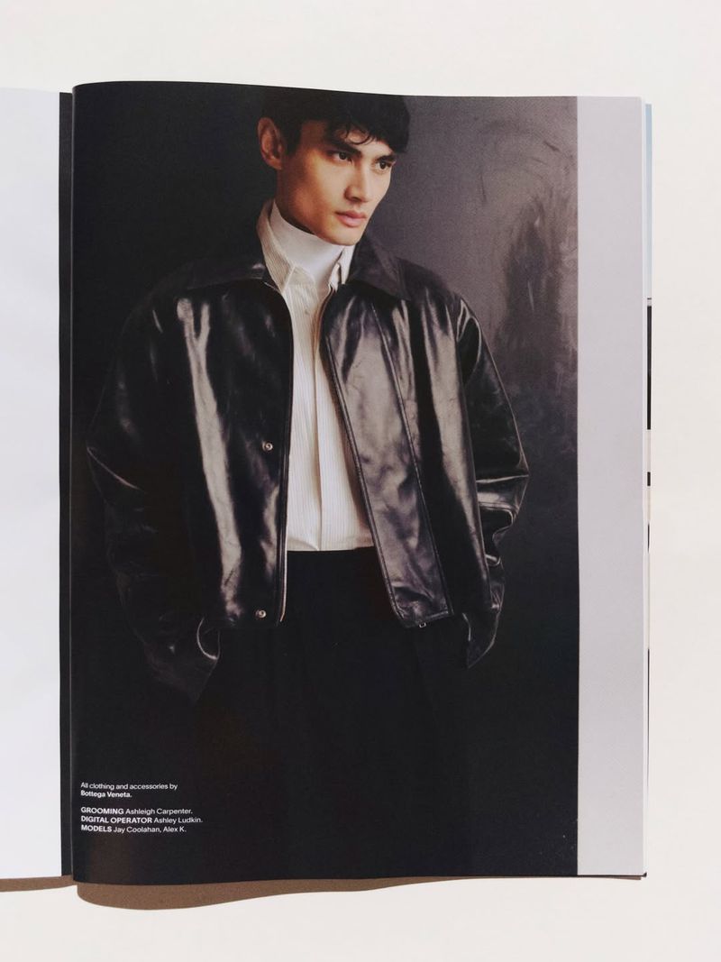 Man wearing a black leather jacket, white shirt, and dark trousers in an editorial fashion spread for Esquire Australia.