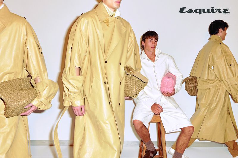 Models in beige leather coats and white outfits holding woven leather bags against a white background for Esquire Australia