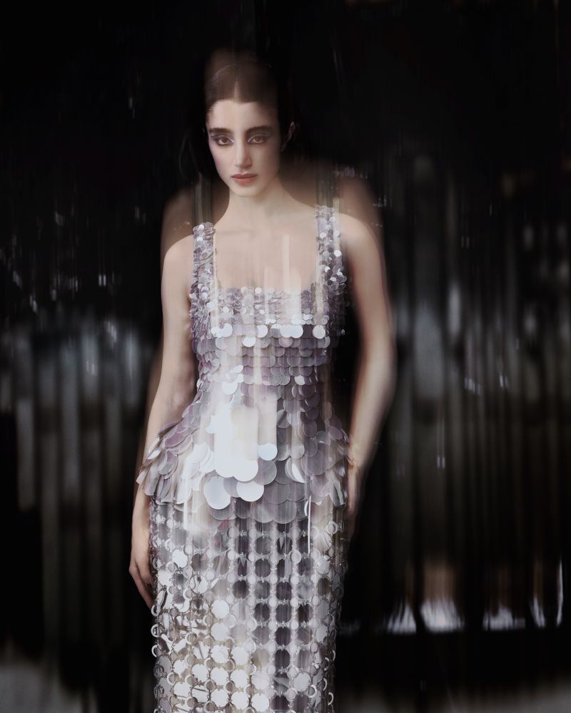 Model wearing a metallic sequin dress in a motion-blurred editorial fashion photograph for Numero Netherlands.