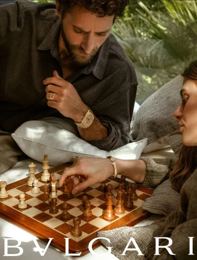Man and woman playing chess outdoors wearing Bulgari jewellery and watches in Love Reborn project