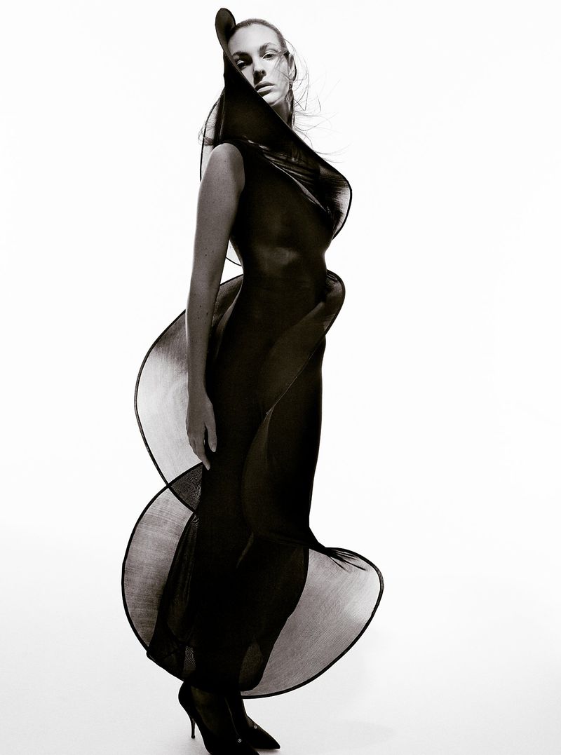 Model Vittoria Ceretti in a structured black dress against a plain white studio backdrop for Beyond Noise