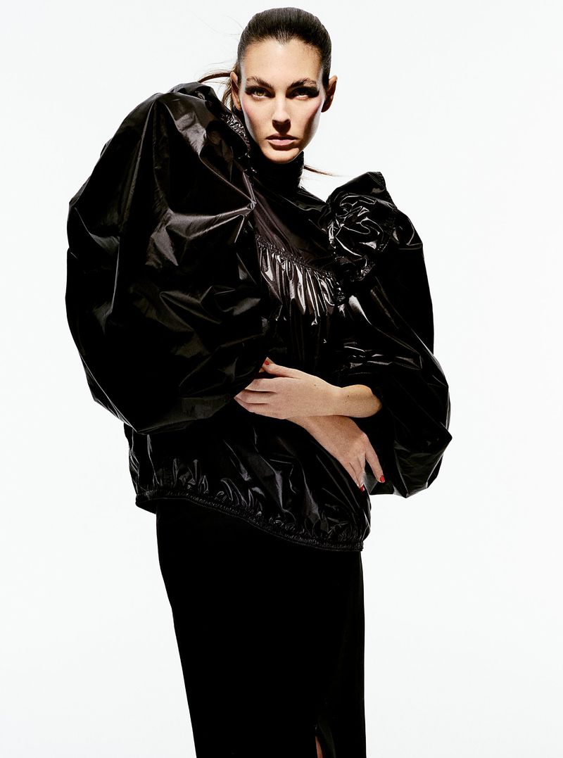 Model Vittoria Ceretti in a glossy black puffed sleeve top against a bright white background for Beyond Noise