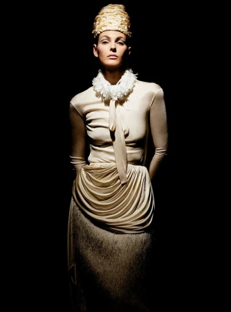 Vittoria Ceretti in a structured beige top and tall sculpted headpiece against a dark background for Beyond Noise Issue 5.
