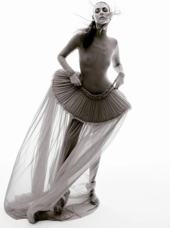 Model Vittoria Ceretti wearing sheer tulle skirt and form-fitting top against a seamless white background for Beyond Noise.