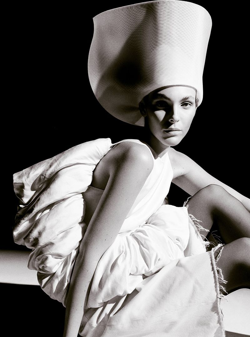 Vittoria Ceretti wearing a white sculptural hat and outfit for Beyond Noise fashion editorial photography by Anthony Seklaoui.