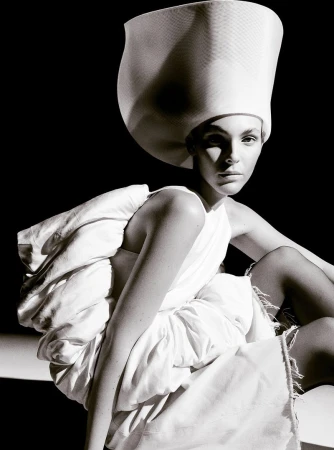 Vittoria Ceretti wearing a white sculptural hat and outfit for Beyond Noise fashion editorial photography by Anthony Seklaoui.