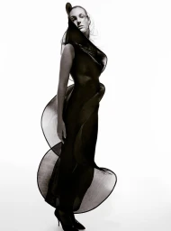 Model Vittoria Ceretti in a structured black dress against a plain white studio backdrop for Beyond Noise